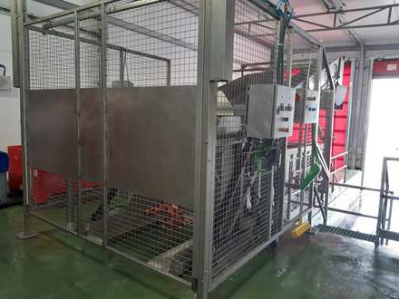 The real bin tipper installation behind its guarding